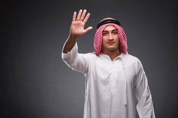 Arab businessman on gray background