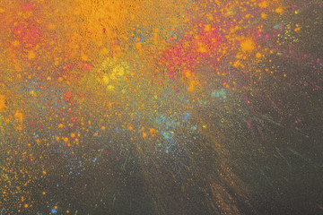 Holi colours on black background