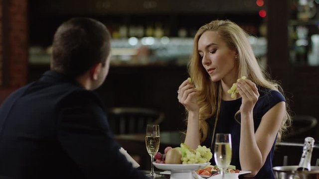 romantic pair drinking champagne in restaurant