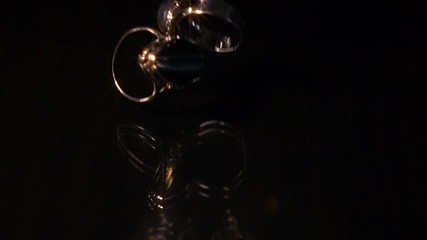 Various Pieces Of Jewelry Fall On Black Reflective Surface, Super Slow Motion. - Powered by Adobe
