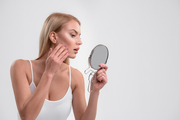 Young woman is caring of her skin