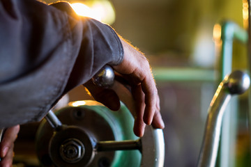 Worker manipulate old machine on factory
