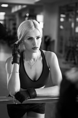 Portrait of a beautiful sexy woman dressed in sports clothes in the gym