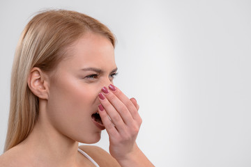 Young woman does not like her breath