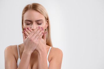 Young woman is dissatisfied with her teeth