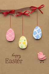 Happy easter / Creative easter concept photo of eggs on a tree made of paper on brown background.