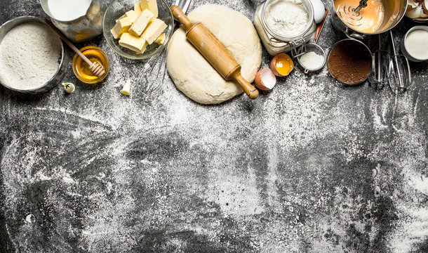 Dough background. Fresh dough with a variety of ingredients on rustic background.