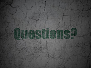 Learning concept: Questions? on grunge wall background