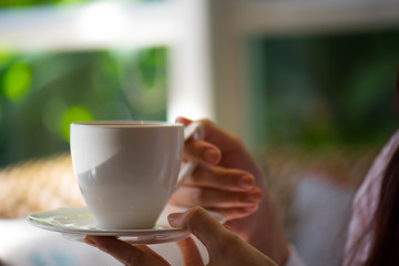 Woman hand holding hot coffee