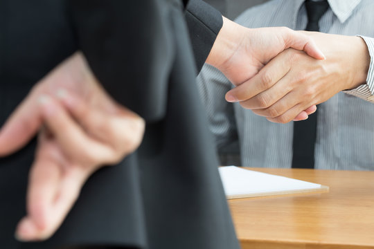 Dishonesty, Business fraud concept, Businessman showing fingers crossed