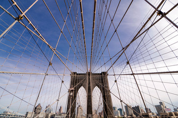 Perfect geometry of the Brooklyn Bridge cable web with overlook on Manhattan vintage colors