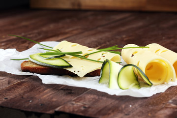 Bread with slices of cheese for lunch table. Sharing antipasti on party or summer picnic time over...
