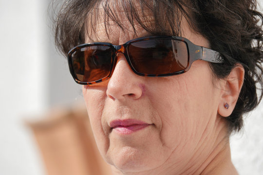 portrait of brunette mature woman with sunglasses
