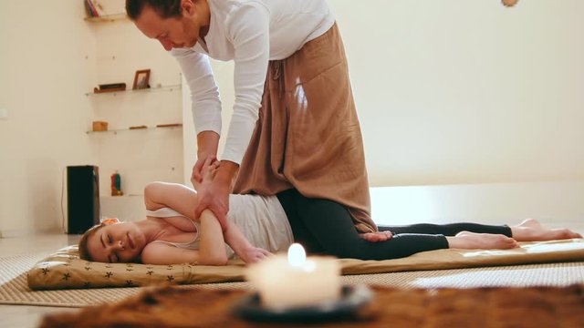 Traditional thailand massage therapy - impact on hands for blonde female model, slider