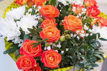 Bunch of big orange red and tea roses