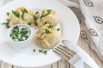 Traditional Turkish manti with sour cream sauce