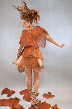 Woman in an orange fancy outfit, fashion, studio