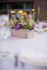 fresh flowers in vases baskets on a table decoration