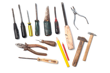 Old vintage tools, pliers, screwdrivers, knife, hammers, pencils, chisel, awl and nippers isolated on white background
