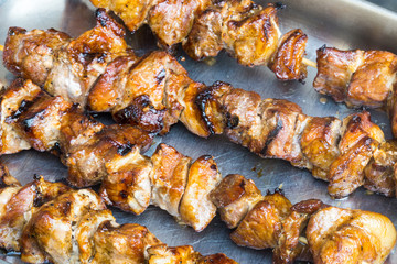 A pork skewer stick on the grill