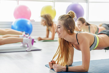 Happy laughing female coach of fitness