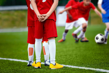 Obraz premium Youth Football Soccer Background. Football Soccer Match for Children. Kids Playing Soccer Game Tournament. Boys Running and Kicking Football. Youth Soccer Footballers Competition