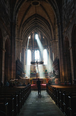 Man stands in main church hall with pews