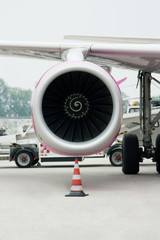 Vertical picture shows the engine of the aircraft, which stands at the airport - 138601011
