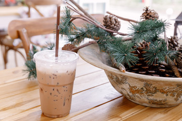 Iced coffee in plastic cups On the table with pine cones