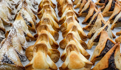 Hamantaschen cookies at bakery display for Purim celebration.