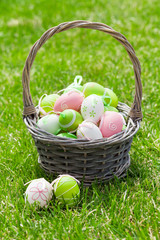 Easter eggs basket on grass