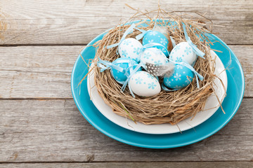 Easter eggs nest on plate