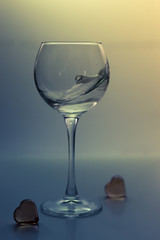 Splash water in a glass on a gray background