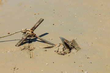 Metall anchor fixed in sand on the beach in An Nang, Thailand