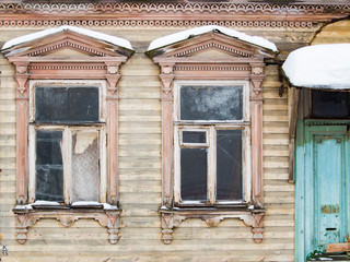 Two historic brown window on the yellow wall