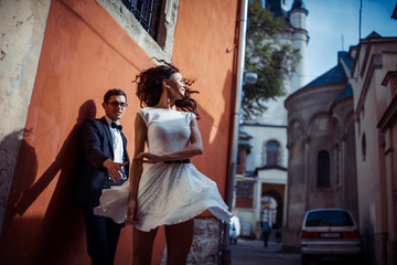 Young couple in love, hugging in the old part of town