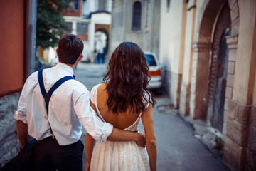 Young couple in love, hugging in the old part of town