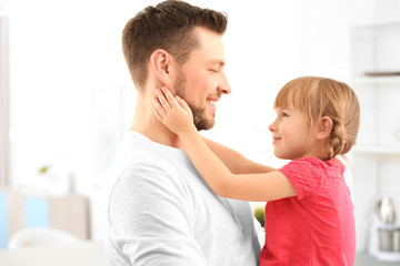 Girl embracing father at home