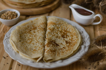 Pancakes with chocolate sauce and nuts for breakfast