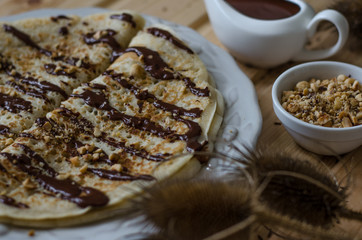 Pancakes with chocolate sauce and nuts for breakfast