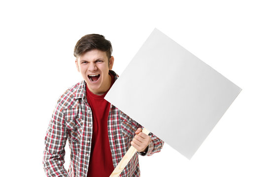 Protesting young man holding placard with space for text on light background