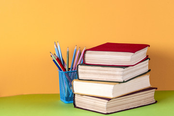 Open book, hardback bookson bright colorful background.
