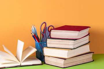 Open book, hardback bookson bright colorful background.