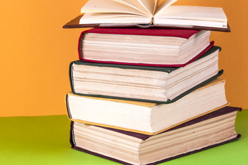 Open book, hardback bookson bright colorful background.