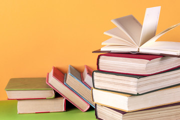 Open book, hardback bookson bright colorful background.