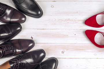 men's and red high heel womens shoes on white background