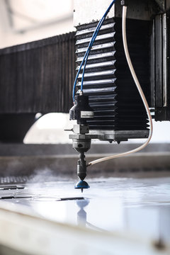 High pressure water jet cutting metal plate.