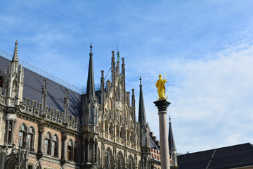 Marienplatz, Munich city scenic skyline view. Cityscape of Munchen architecture under blue sky. New Town Hall and Frauenkirche Bavaria, Germany.  Unfiltered. Famous tourist and traveler routs.