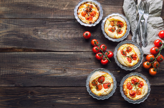Fresh homemade tarts with cherry tomatoes and goat cheese