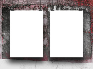 Two blank frames hanged by clips against red and black concrete wall background